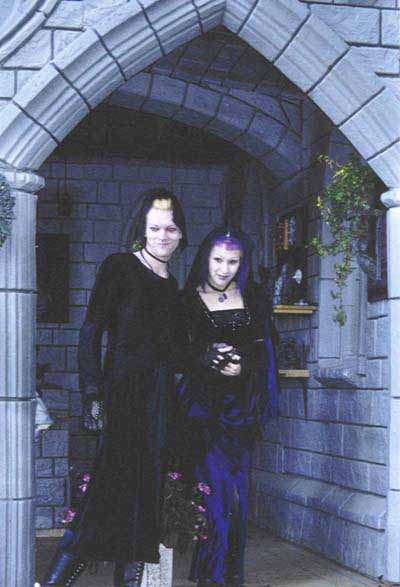 Two female Goths standing in front of the Booth