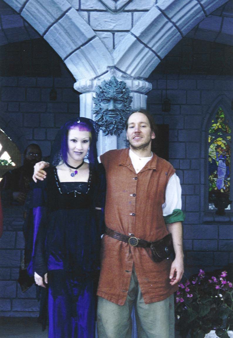 Tomak and an unknown Goth stand beneath a Green Man sculpture.