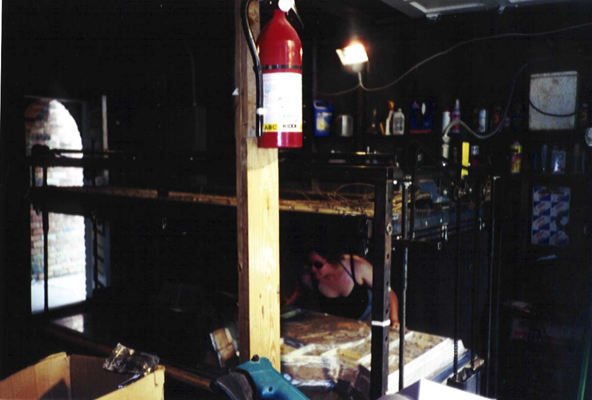Erin setting up a mold on      the vacuum former in Guy's garage