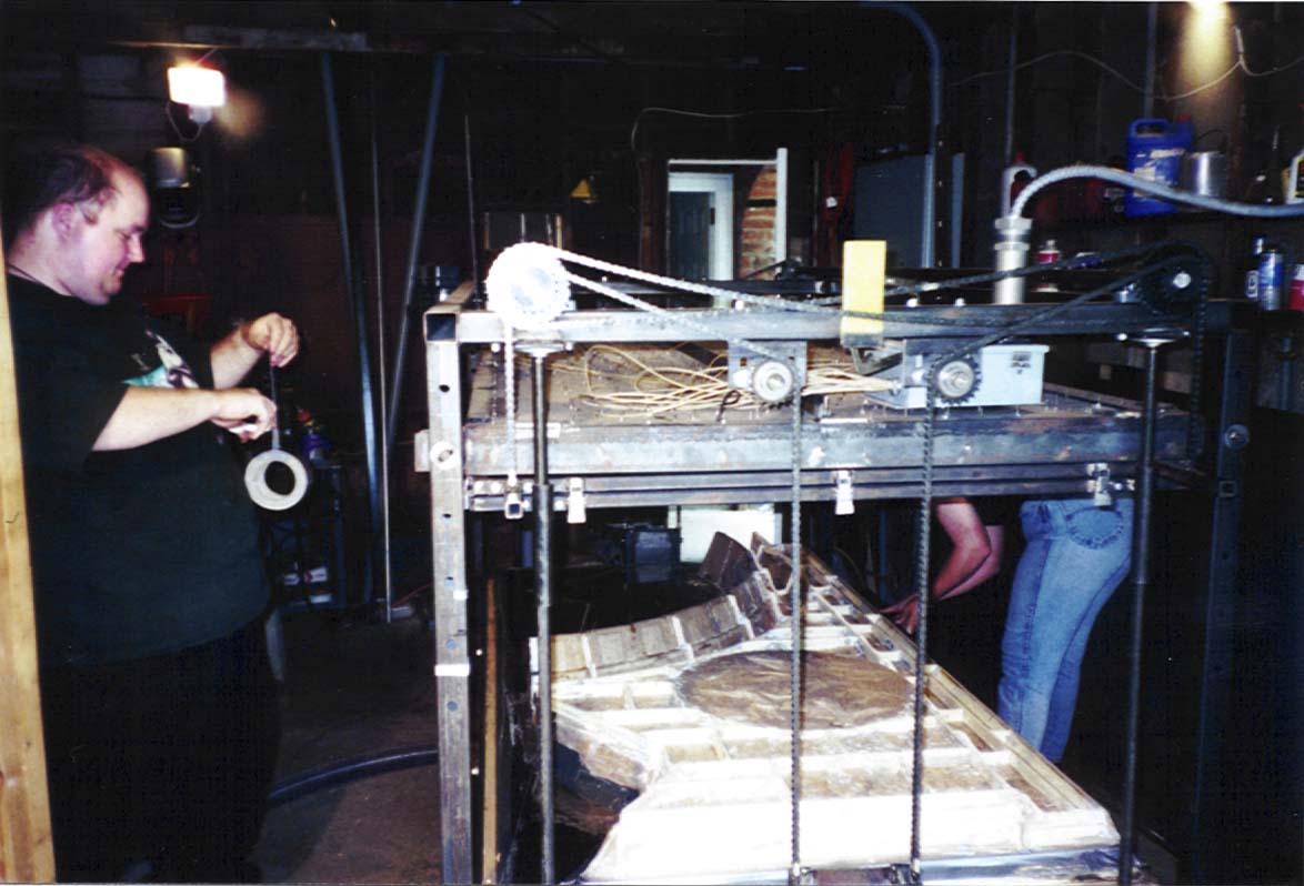 Rorik duct tapes a mold into place on the vacuum former.