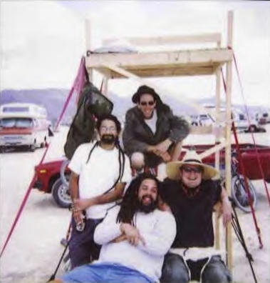 4 guys in a wooden cart