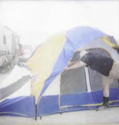 Johann grips his tent during a sandstorm