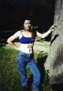Claire, wearing a halter top and jeans, has the word 'sin' written in huge letters on her stomach above an arrow pointing down.