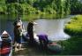 People standing by a canoe.