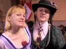 Solveig in random Rennie garb complete with carnation in her bosom, Kendra wearing Elizabethan garb and period Stupid Hat