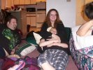 Aisling snuggles Solveig in plaid pajamas as Big Tom and Hawk look on